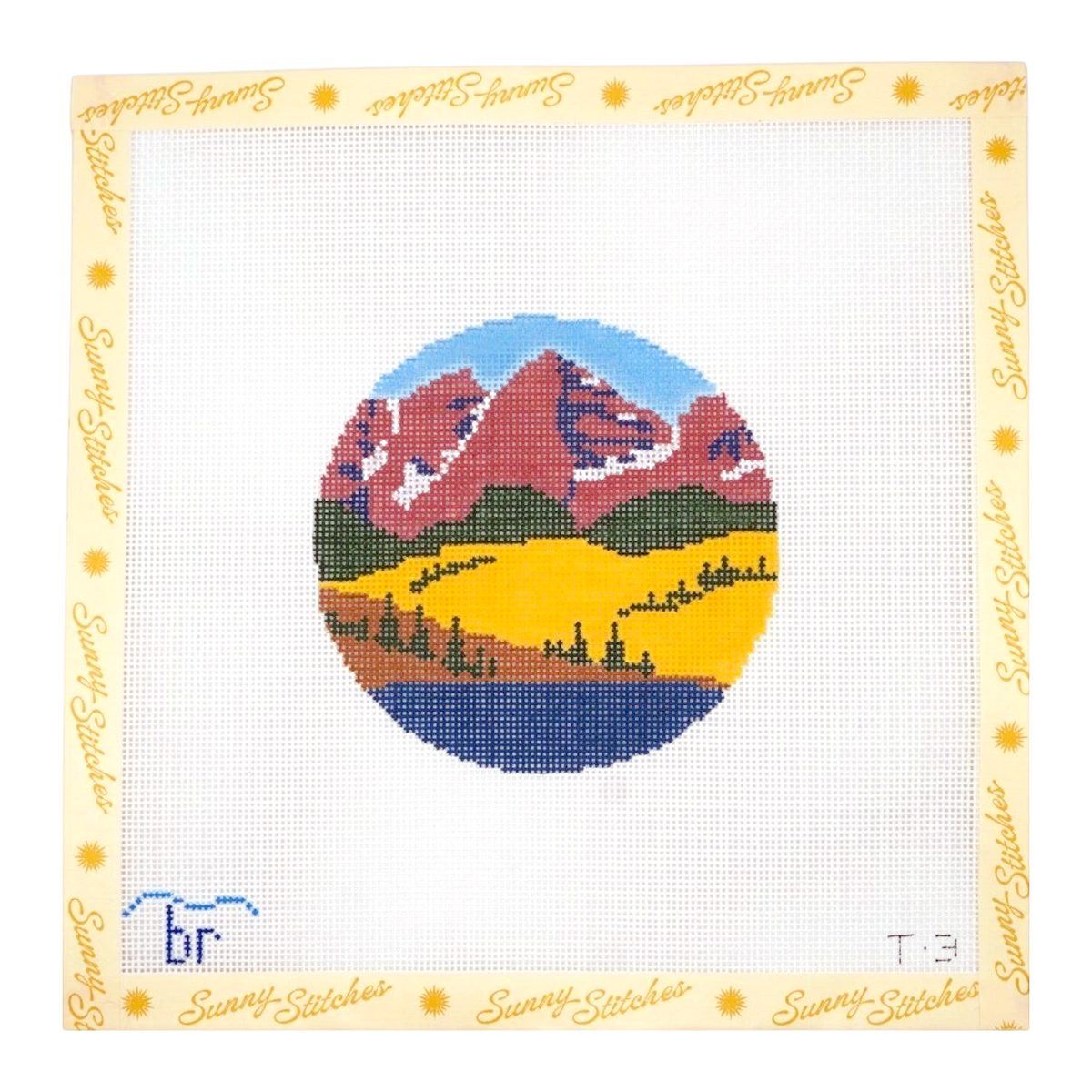 A square canvas needlepoint or cross-stitch design featuring a mountain landscape with red-brown peaks, green hills, a yellow valley, and blue water under a light blue sky. The design is centered on a white grid background with a cream border printed with the brand name 'Sunny Stitches'.
