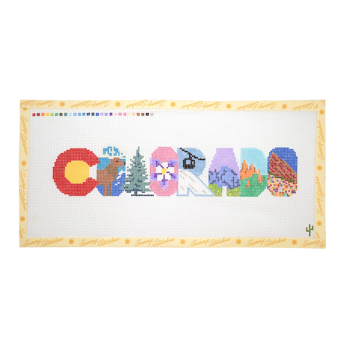 A cross-stitch pattern spelling out 'COLORADO' using state symbols and landscapes, framed by a beige border with 'Santa Fe Designs' script and a small cactus logo, on a white background. From Sunny Stitches.