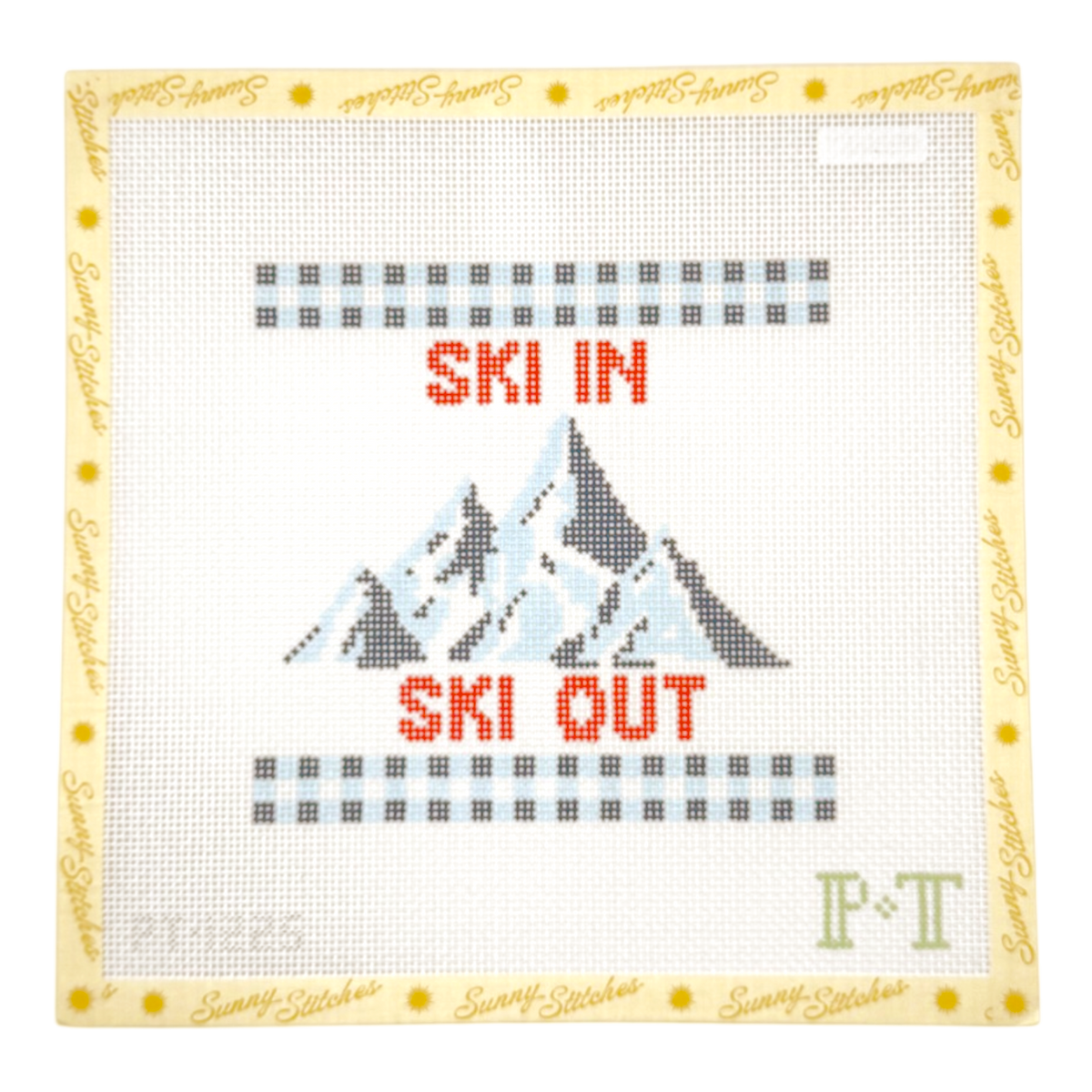 A square cross-stitch canvas featuring a mountain design with the words 'SKI IN' above and 'SKI OUT' below in red-orange lettering. The center has a stitched mountain motif in gray, black, white, and light blue, with gray dotted border lines above and below.