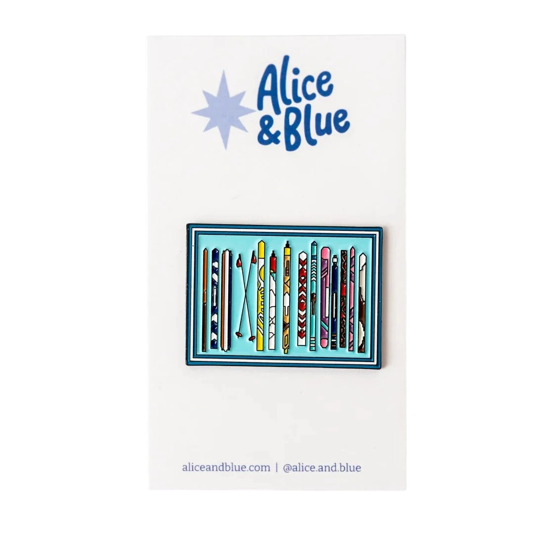 Sunny Stitches Tips Up needleminder featuring a colorful ski-themed enamel design on a white display card