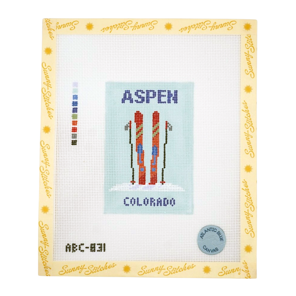 A counted needlework canvas by Sunny Stitches featuring a cross-stitch design of skiers in Aspen, Colorado. The canvas has a white mesh grid, a central light blue square with the text 'ASPEN' and 'COLORADO' in blue, and two pairs of red and orange skiers with black poles.
