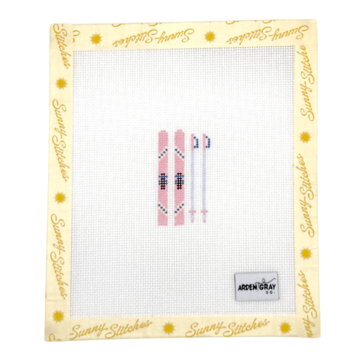 A square white needlepoint canvas with a decorative border featuring a pink ski set. The border is pale yellow with the brand name 'Sunny-Stitches' printed repeatedly in gold script and small gold sun icons.