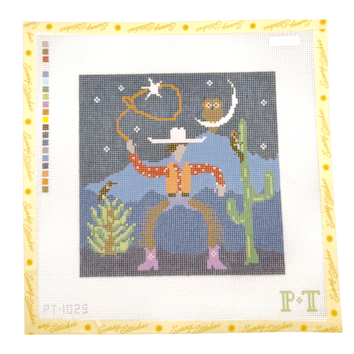 A square canvas needlepoint design by Paint It Again, featuring a mountain cowboy in a sunset vest and hat with a lasso, under a crescent moon and owl, with a cactus and mountains in the background. The canvas is framed with a yellow border containing the brand name 'Sunny Stitches' and a color chart on the left.